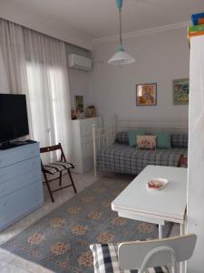 a living room with a couch and a table at Rena's Traditional Aegean House by the Sea in Perea