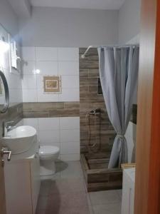 a bathroom with a toilet and a sink and a shower at City Center Beauty in Serres