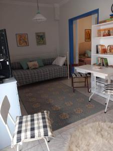 a living room with a couch and a table at Rena's Traditional Aegean House by the Sea in Perea