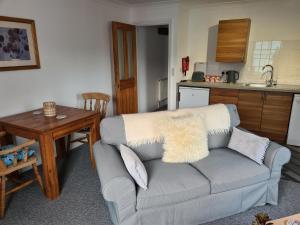 a living room with a couch and a table at Beautiful Apartment 3 Mins To The Beach in St. Leonards