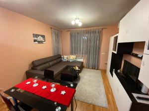 a living room with a couch and a table at Mia's Apartment, Stylish One Bedroom Suite in Sofia