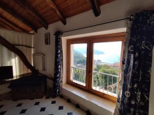 a room with a large window with a view at Palinuro Romantic panoramico al centro del paese in Palinuro