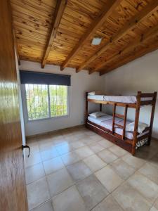 ビージャ・ルミパルにあるComplejo Cielo Azulの二段ベッド2組、木製の天井が備わる客室です。