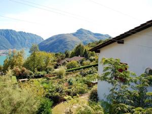 a house with a view of a river and mountains at Casa Dina in Lugano