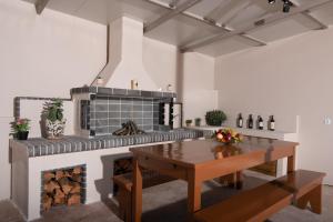 a kitchen with a table and a fireplace at Cinque Terre Iakinthi in Zakynthos Town