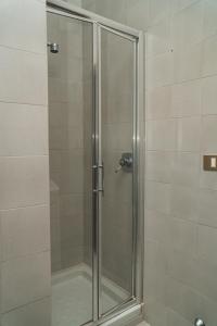 una doccia con porta in vetro in bagno di Casa Vacanze Civico 19 a Matera