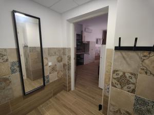 a bathroom with a walk in shower and a mirror at Apartamentos Pueblo Mar in Calpe