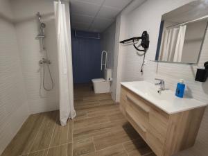 a bathroom with a sink and a shower and a toilet at Apartamentos Pueblo Mar in Calpe