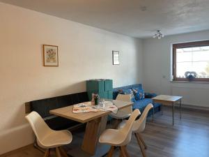 a living room with a table and chairs and a couch at Margit Eberharter in Hainzenberg