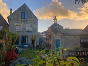 an old house with a tower on top of it at Huis van Marietje in Aardenburg