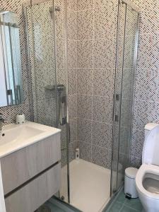 a bathroom with a shower and a sink and a toilet at Porto Plage de Matosinhos in Matosinhos