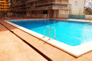 a large swimming pool with blue water in a building at desolyplaya Colomeras 3T in Oropesa del Mar
