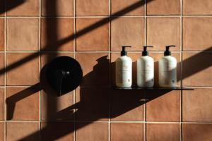 a shadow of three bottles on a tiled wall at Hotel Thaxter in Portsmouth