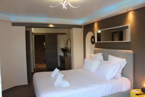 a bedroom with a bed with white sheets and pillows at Residence Les Jardins De Natallia in La Seyne-sur-Mer +145 photos
