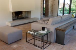 a living room with a couch and a fireplace at Relais Casale Valigi in Narni