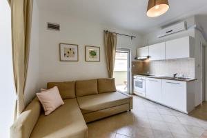 a living room with a couch and a kitchen at Zara 2 in Kruševo +17 photos