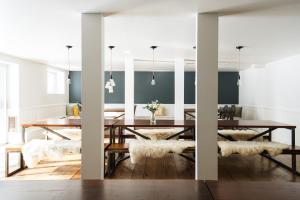 a dining room with a wooden table and white walls at Le Couvent Val-Morin in Val-Morin