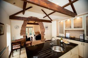 a kitchen with a sink and a counter top at Beckside Cottage, Netherby, near Carlisle in Longtown