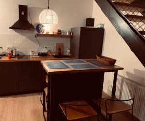 a kitchen with a wooden table with a counter top at Mariam's Stunning and Sunny Apt in Gudauri