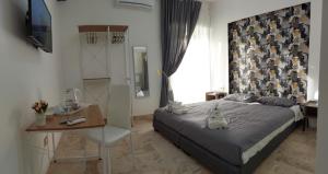 a bedroom with a bed and a table and a desk at PANORAMICO in Catania