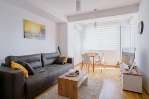 a living room with a couch and a table at Ana Kraljevo in Kraljevo