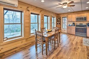 cocina con paredes de madera, mesa de madera y sillas en Secluded Black Mountain Cabin with On-Site Pond!, en Black Mountain