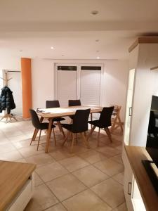 a dining room with a wooden table and chairs at Casa Mediteran NEU in Reichensachsen