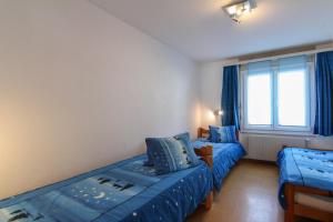 um quarto com duas camas e uma janela em Casa Yolanda Familienwohnung Mireille em Fieschertal