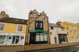 a group of buildings on a city street at The Drapery, Haltwhistle in Haltwhistle