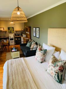 a bedroom with a bed and a living room at Cheverells Farm in Grabouw