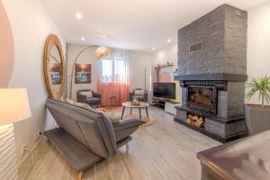a living room with a chair and a fireplace at ForestPlage Gîte avec SPA nordique in Cognac-la-Foret