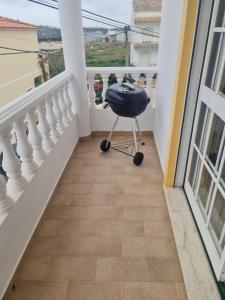 a black chair sitting on a balcony with a view at Portimão Paradise - Spacious Family Villa in Portimão