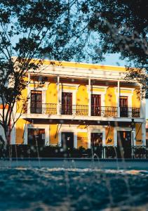 a white building with a balcony in front of it at Ponce Plaza Hotel & Casino in Ponce