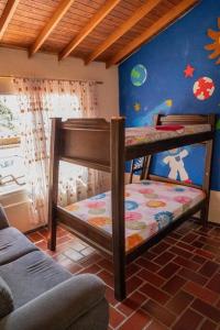 a bedroom with two bunk beds in a room at Finca El paraíso Guatape in Guatapé