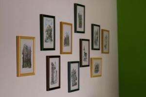 a group of framed pictures on a wall at Silva Cabin - In the heart of Bran, next to the Castle w/ free parking in Bran