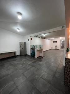 an empty room with a large room with a large tile floor at Casa Grace in Emiliano Zapata