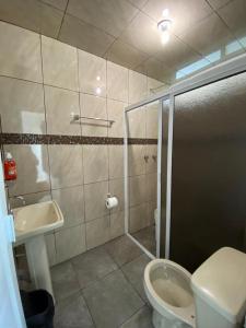 a bathroom with a shower and a toilet and a sink at Casa Grace in Emiliano Zapata
