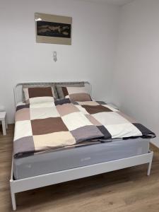 a bed sitting in a room with at Stara Jezica Apartments with WiFi in Ljubljana