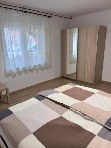 a bedroom with a large bed and a checkered floor at Stara Jezica Apartments with WiFi in Ljubljana