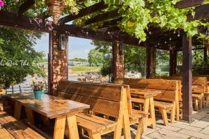 a group of wooden benches and tables in a pavilion at Mill on the Exe in Exeter