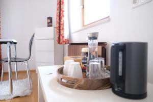 a kitchen counter with a coffee maker on a counter at Doppelzimmer in Innsbruck