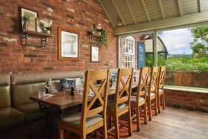 a dining room with a wooden table and chairs at Mill on the Exe in Exeter