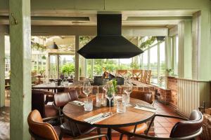 a dining room with a table and chairs at Mill on the Exe in Exeter +37 photos