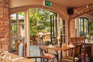 a restaurant with tables and chairs on a patio at Mill on the Exe in Exeter