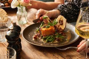 a plate of food on a wooden table with a plate of food at Mill on the Exe in Exeter