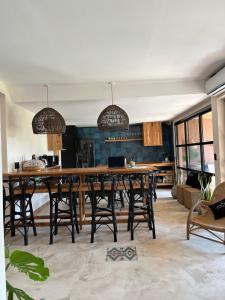 a dining room with a large wooden table and chairs at Tanah Host - Casa de Huespedes in Villa Mercedes