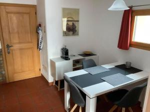a room with a table and chairs and a door at Aivla in Celerina