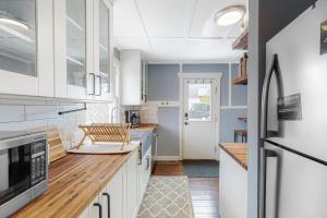 a kitchen with white cabinets and a refrigerator at Rocky Mountain Resting Place in Estes Park