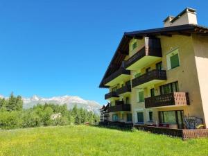 a building on a hill with mountains in the background at Curtins16 in Pontresina