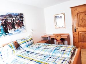a bedroom with a bed and a picture on the wall at Curtins16 in Pontresina